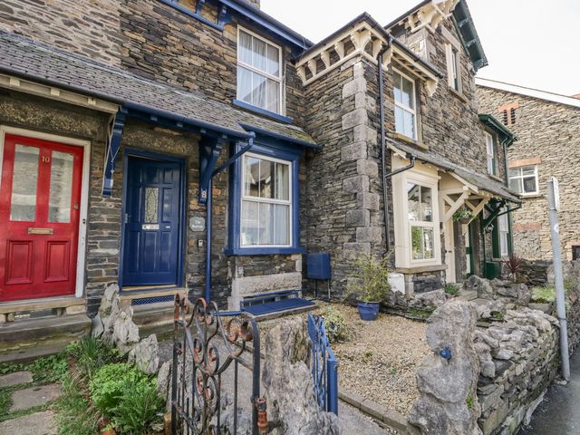 A stone house with red and blue doors at The Burrow in Windermere