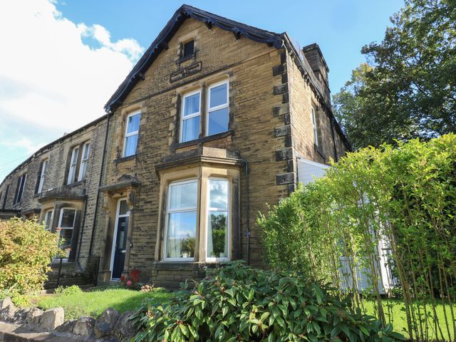 A house with multiple windows and bushes at 27 Calton terrace Skipton