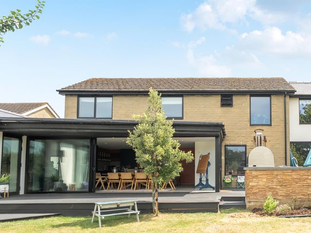 An outdoor area with a house and seating at Manor Farm House in Merton near Bicester