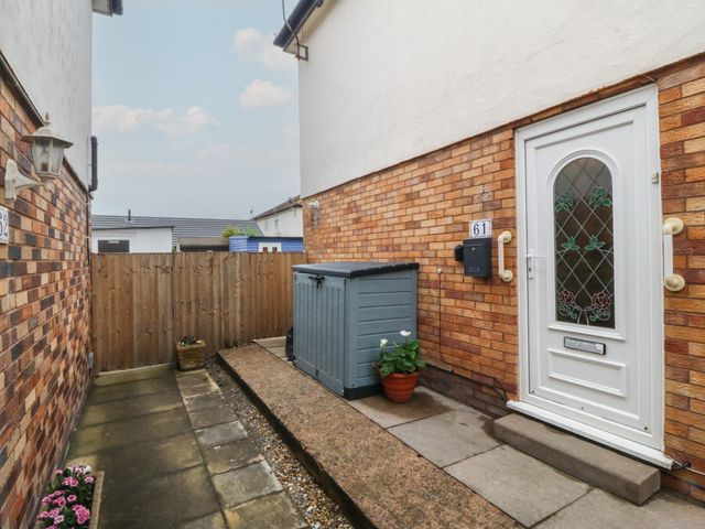 An outdoor area with a door and a shed at 61 Lloyd Street West in Llandudno