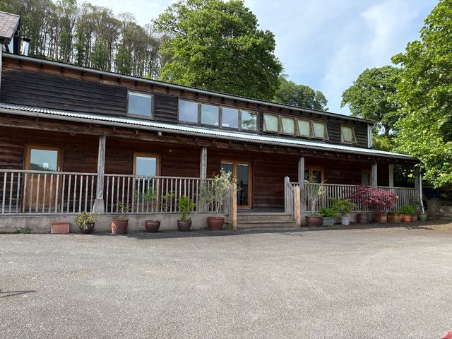 A wooden building with windows and porch at Cottage 2 in 