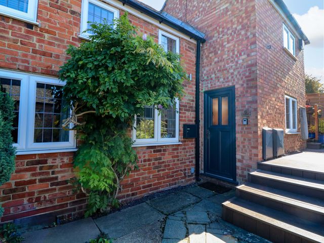 An outdoor area with a door and brick wall at 6 Brook Court Thulston near Derby