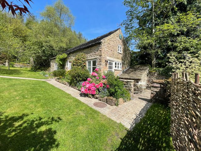 A cottage with flowers and a pathway outside at Pigwig Cottage Longway Bank near Crich