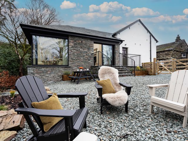 A garden with outdoor chairs and a picnic table at The Old Bunkhouse in Grasmere