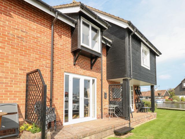 An outdoor area with a patio and furniture at Cotman Cottage Norwich