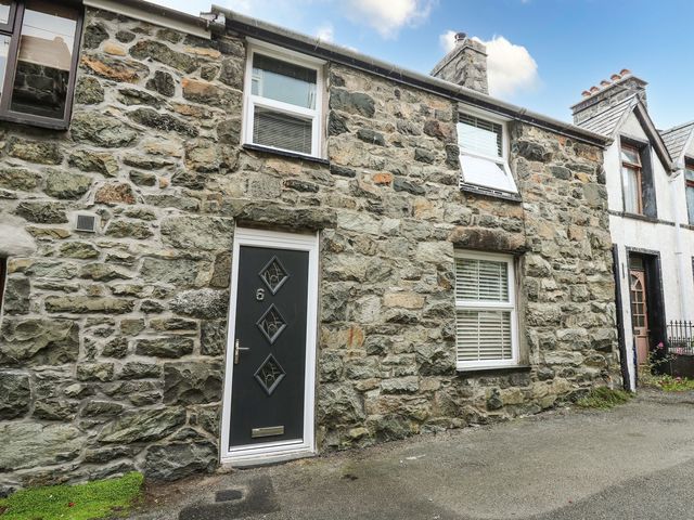 A stone wall with a front door and windows at 6 Upperfield Street in Dolgellau