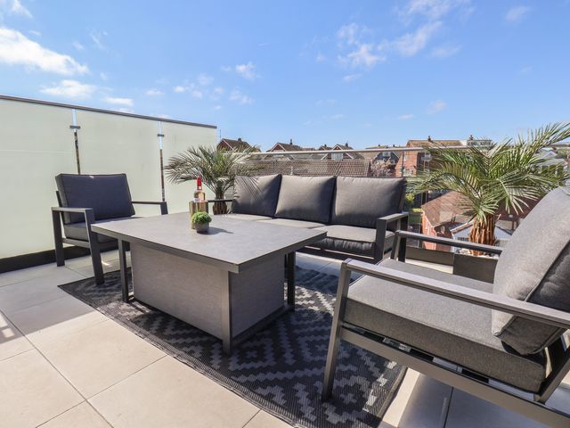 An outdoor terrace with seating and a table at Falcon Luxe in Whitby