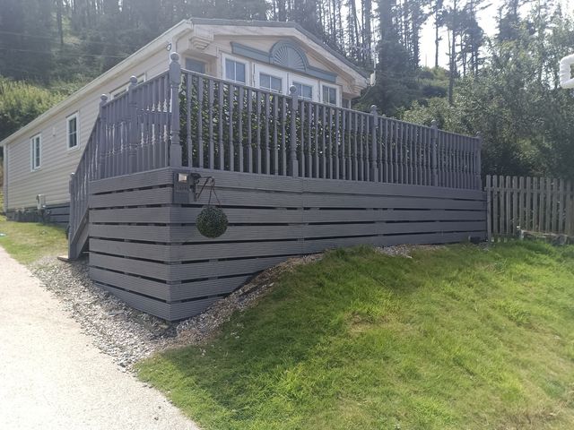 An outdoor area with a house, deck, and steps at Clarach Bay Holiday Village - Holiday Accommodation 10536 Aberystwyth