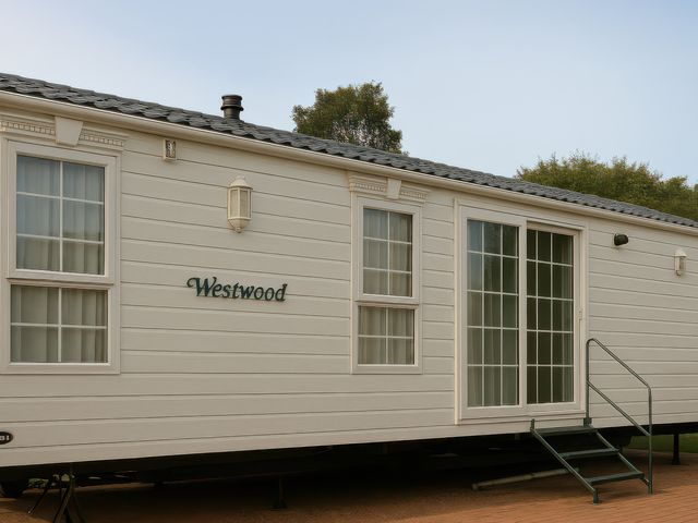A mobile home exterior with a door and windows at Combe Haven Holiday Park - Holiday Accommodation 12122 St. Leonards-on-Sea