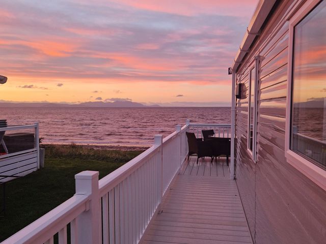 An outdoor area with a deck and furniture at Craig Tara Holiday Park - Holiday Accommodation 12278 Ayr