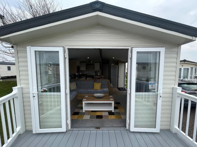 A living room with a sofa and coffee table at Trecco Bay - Holiday Accommodation 17447, Porthcawl