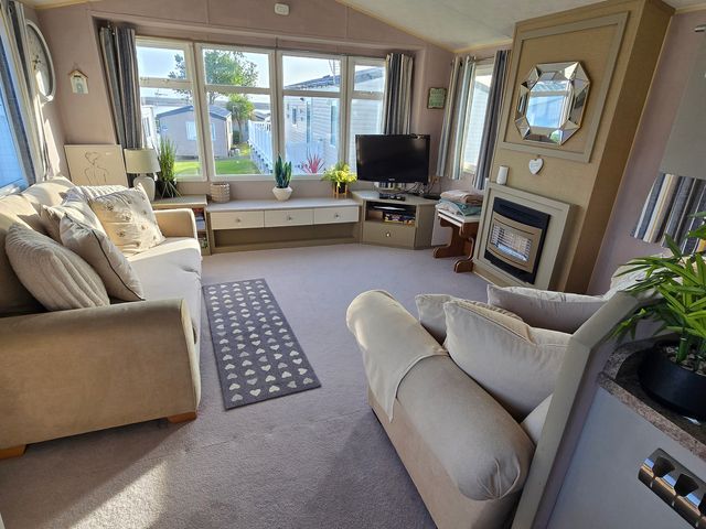 A living room with a sofa and television at Littlesea Holiday Park - Holiday Accommodation 19270, Weymouth