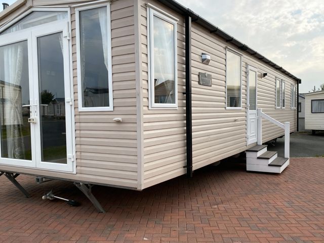 A mobile home with windows and steps at Lyons Robin Hood - Holiday Accommodation 20871 Rhyl