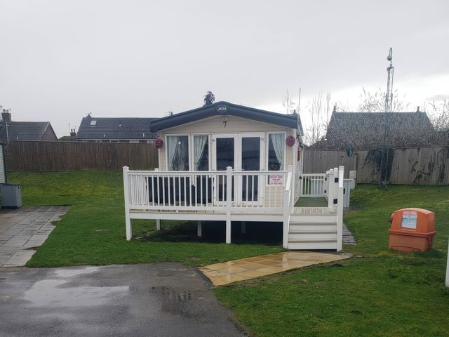A holiday home with a deck at Marton Mere Holiday Village - Holiday Accommodation 20877 Blackpool