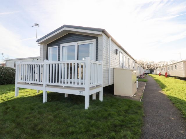 A holiday home with a deck and pathway at Cala Gran Holiday Park - Holiday Accommodation 20962 Fleetwood