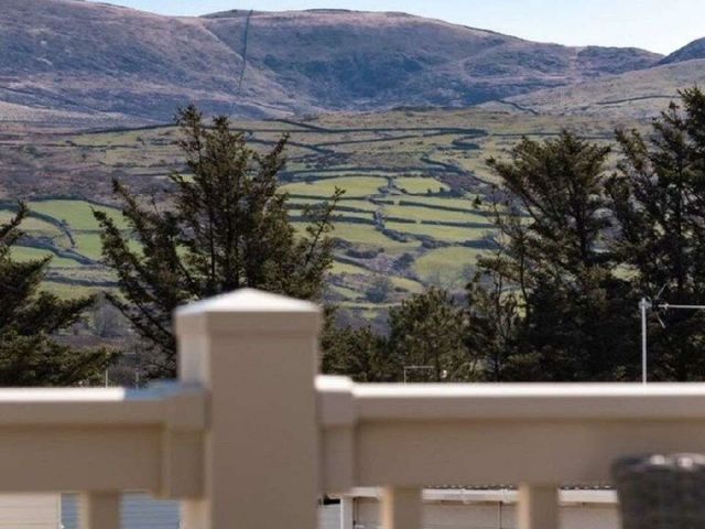a view of rolling hills and green fields from a balcony at Barmouth Bay Holiday Village - Holiday Accommodation 21428 Talybont