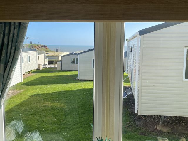 A view from a window showing holiday homes and grass at Devon Cliffs Holiday Park - Holiday Accommodation 21624 in Exmouth