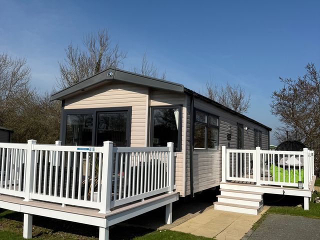 A holiday home with a deck and steps at Hafan y Mor Haven - Holiday Accommodation 22224 in Pwllheli