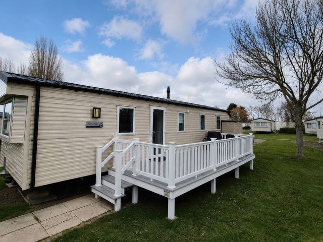 A caravan with decking and steps at Butlins Minehead - Holiday Accommodation 22343 Minehead