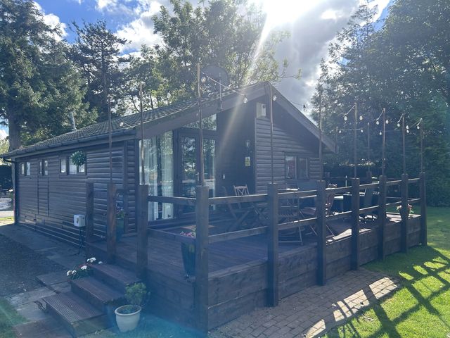 An outdoor deck with chairs and table at Haggerston Castle - Holiday Accommodation 3441 Berwick-upon-Tweed