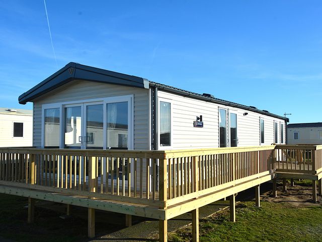 A mobile home with a deck at Perran Sands - Holiday Accommodation 4301 Perranporth