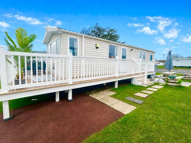 A mobile home with a deck and steps at 62 Snowdonia View, Hafan y Mor Haven - Pwllheli