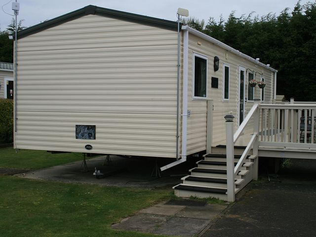 A mobile home with steps leading to a deck at Southview Holiday Park 7251 Skegness