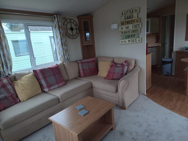 A living room with a sofa and coffee table at Aberystwyth Holiday Village - Holiday Accommodation 9213, Aberystwyth