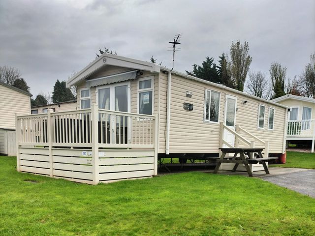 A mobile home with decking and steps at Beverley Bay Holiday Park - Holiday Accommodation 9506 Paignton