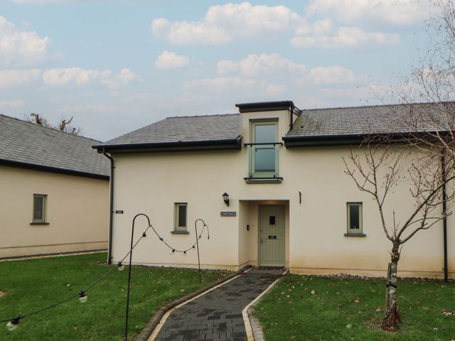 A house with a pathway and garden at Oak Tree Cottage in Swansea