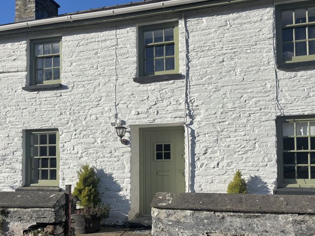 A house exterior with windows and a door at Millers Cottage in Newcastle Emlyn