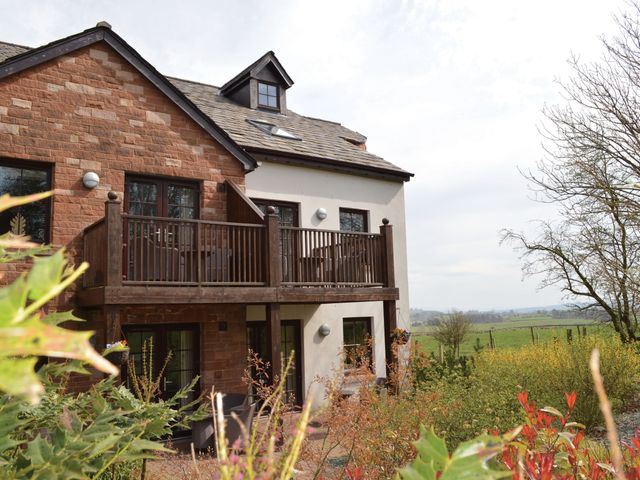 A house exterior with balcony and garden at Ullswater Apartment in Penrith