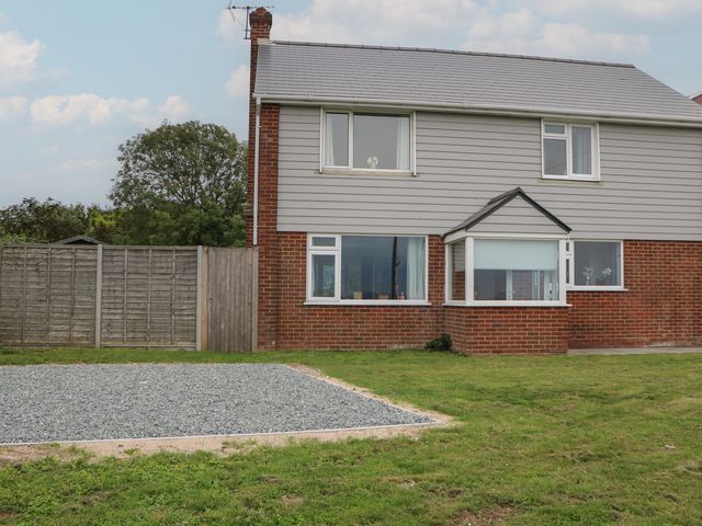 A house with a garden and gravel area at Walmer Court Farmhouse in Deal