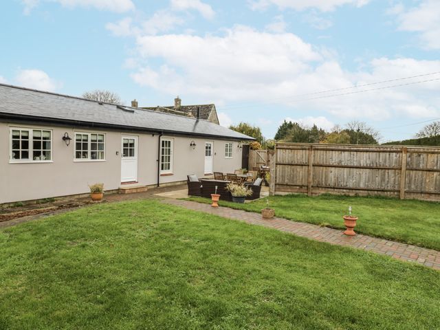 A garden with a patio area and furniture at Rose Stables Black Bourton near Bampton