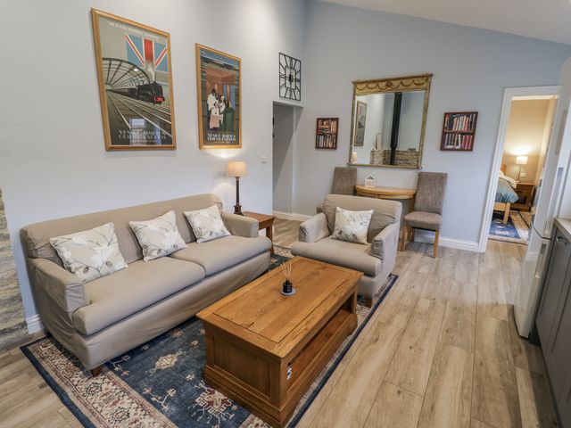 A living room with a sofa and armchair at Rose Stables Black Bourton near Bampton