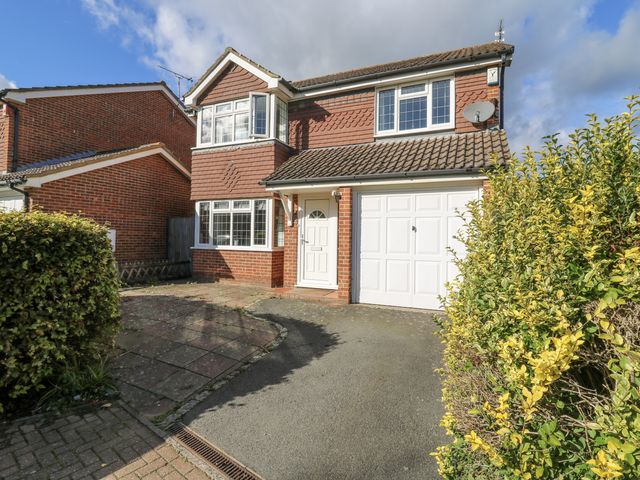 A house with a garage and front door at 32 Abbey Gardens