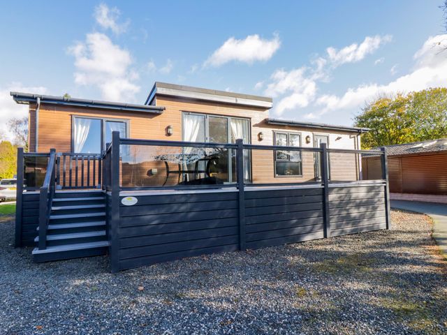 A house with a deck and stairs at 7 Lake View, Lake View 7, White Cross Bay near Windermere