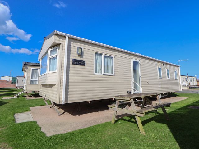 A static caravan with a picnic table outside at A5 Static Caravan Rhyl