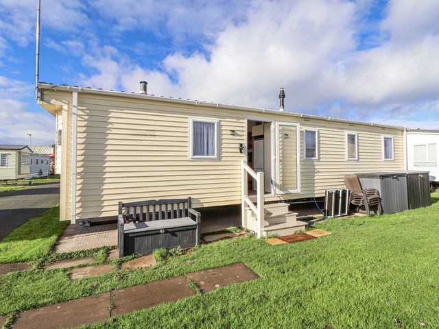 A caravan with steps and bench at Chappie's Caravan - Rhyl 8 Rhyl