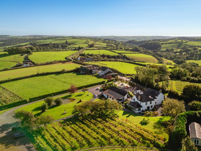 An aerial view of a property surrounded by fields and gardens at Jabajak in Whitland
