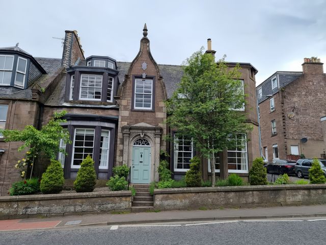 A house with a door and windows at Rowan Tree House in Brechin