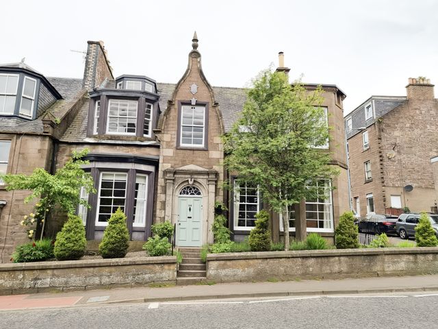 A house with windows and a door at Rowan Tree House Brechin
