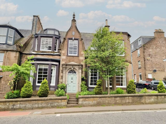 A house with an entrance and trees at Rowan Tree House in Brechin
