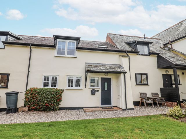 A house with garden and chairs at Rushmoor Cottage in Colaton Raleigh