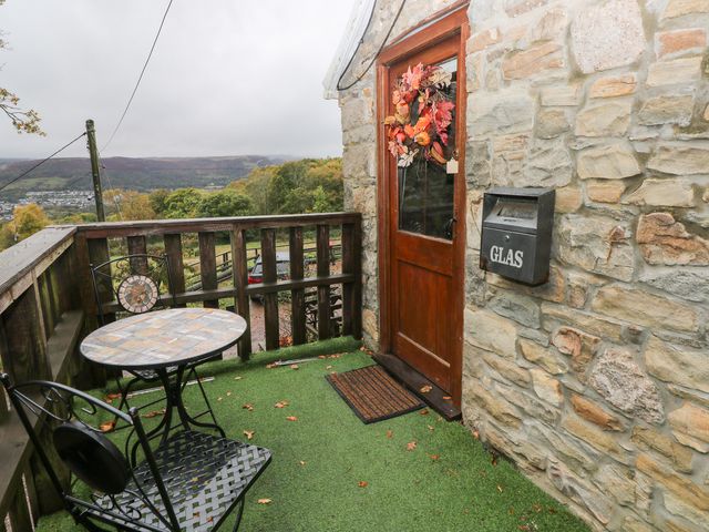 An outdoor area with a table and chair at Glas Studio in Aberdare