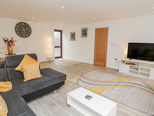 A living room with a sofa and television at Station House Scredington near Osbournby