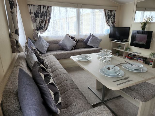 A living room with a sofa and table set at 123 Elms in