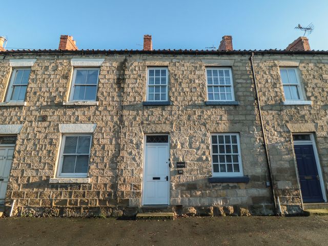 A stone house with multiple windows and a front door at Daisy cottage Pickering