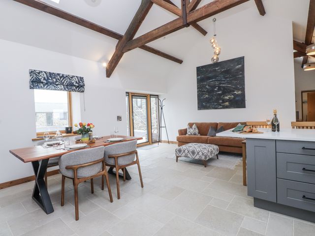 A living room with a dining table and sofa at 2 Trem Y Mor in Llanfwrog near Llanfachraeth
