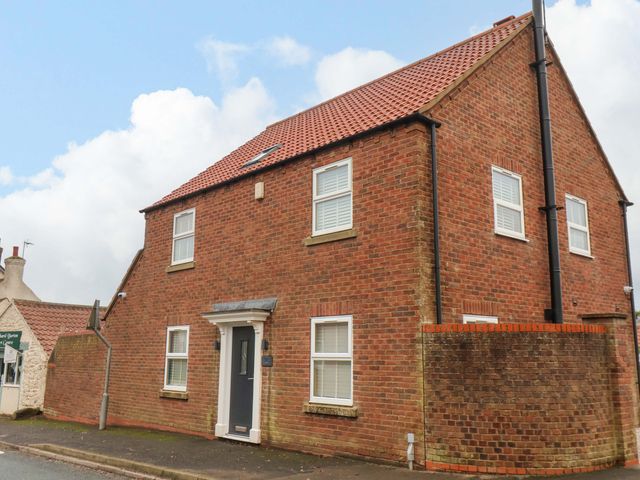 A house with a brick exterior and windows at 23 Main Street